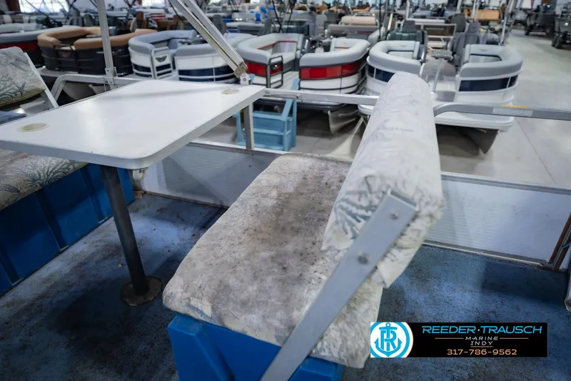 Slide: The Image of Interior of a 1993 Godfrey SW 180 boat with seating and table. - 24