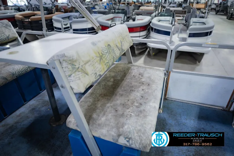 Slide: The Image of 1993 Godfrey SW 180 boat interior with worn seating in showroom. - 25