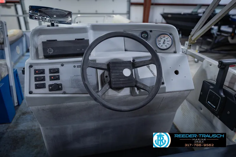 Slide: The Image of Steering console of a 1993 Godfrey SW 180 boat with controls and gauges. - 27