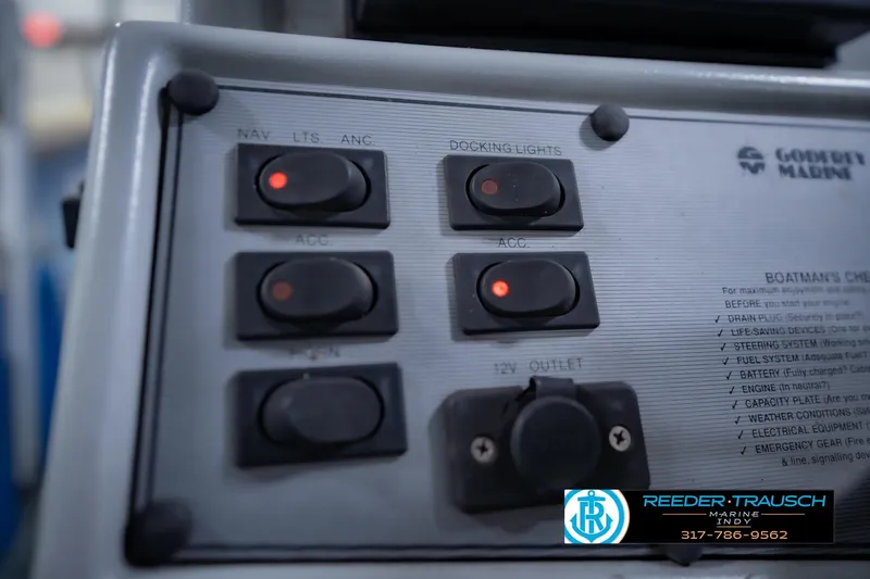 Slide: The Image of Control panel of a 1993 Godfrey SW 180 boat with labeled switches and indicators. - 29