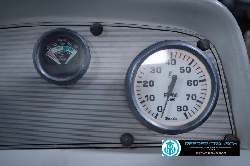 Slide: The Image of Dashboard gauges of a 1993 Godfrey SW 180 boat, featuring RPM and fuel indicators. - 31