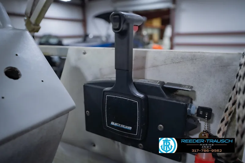 Slide: The Image of Close-up of a 1993 Godfrey SW 180 boat throttle control in a workshop setting. - 32