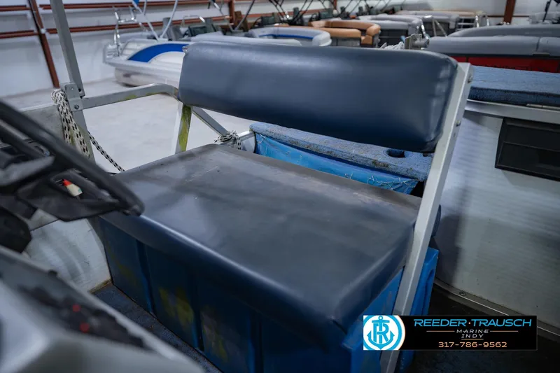 Slide: The Image of Boat seat on a 1993 Godfrey SW 180, in a showroom setting. - 33