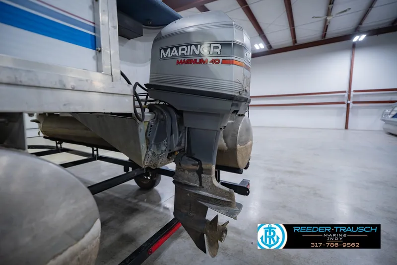 Slide: The Image of Outboard motor on a 1993 Godfrey SW 180 boat in a showroom. - 40