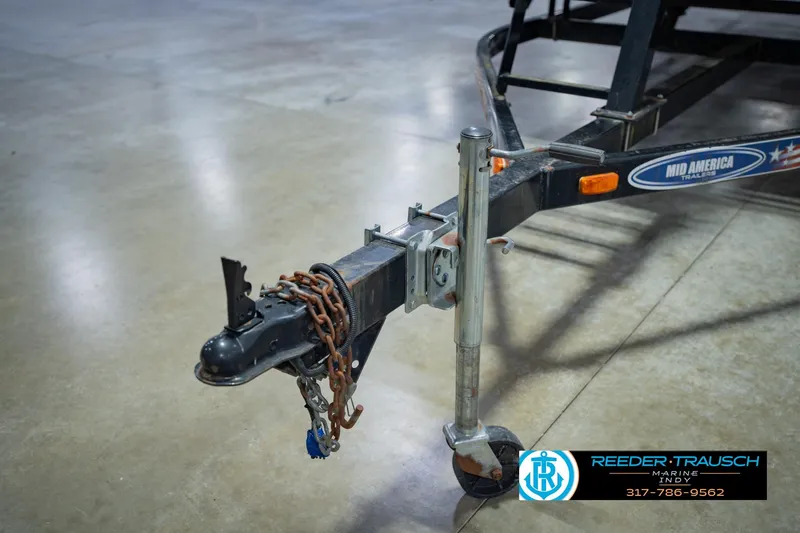 Slide: The Image of Trailer hitch of a 1993 Godfrey SW 180 with chains and wheel jack. - 46