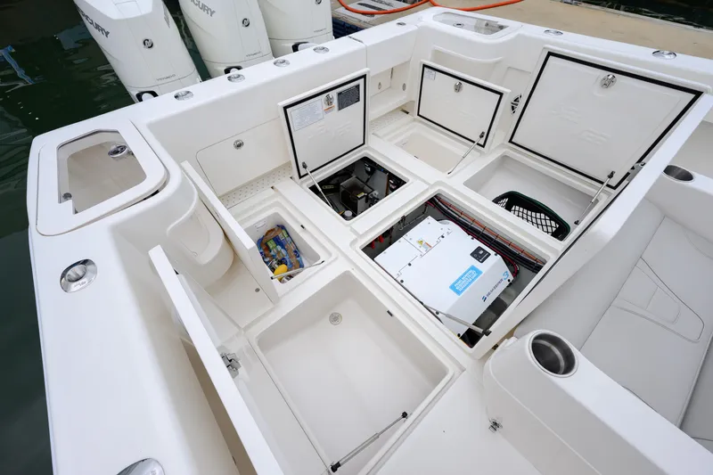 Slide: The Image of 2025 SeaVee 370Z boat deck with open storage compartments and visible engine components. - 9