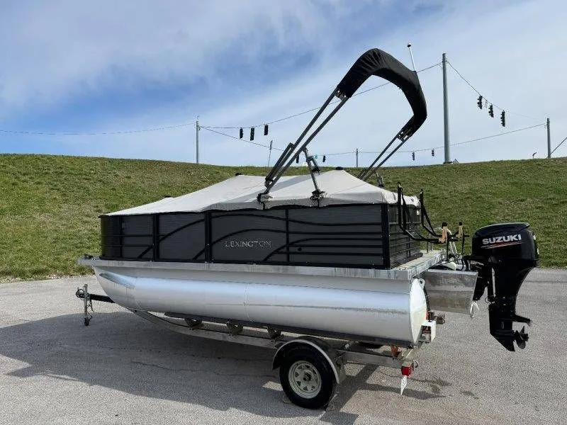 Slide: The Image of 2018 Lexington 5 Series pontoon boat with Suzuki motor on trailer. - 11