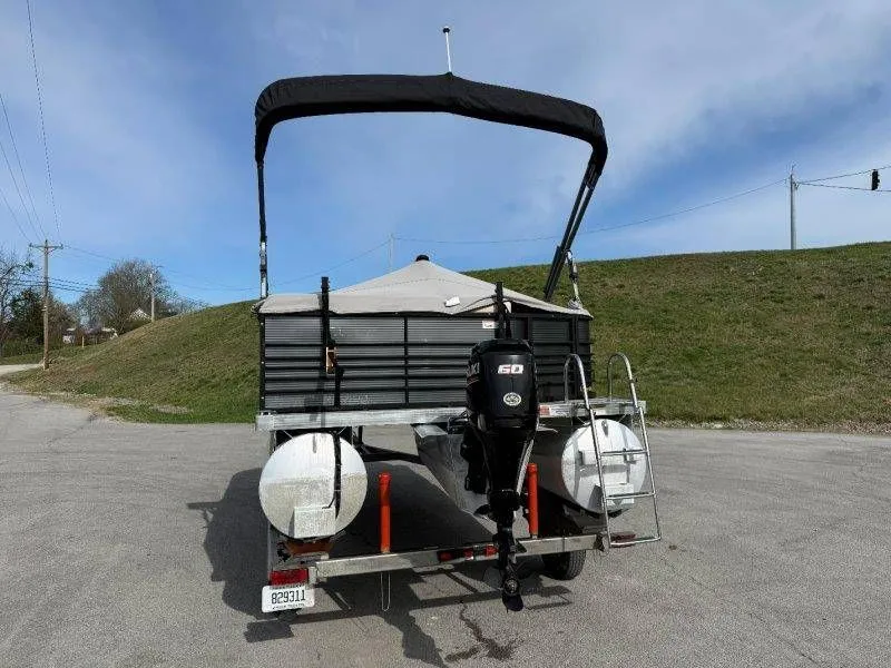 Slide: The Image of Rear view of a 2018 Lexington 5 Series pontoon boat with outboard motor. - 12