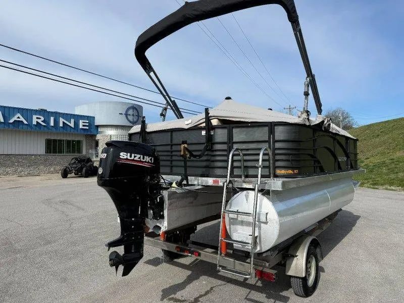 Slide: The Image of 2018 Lexington 5 Series pontoon boat with Suzuki motor on trailer. - 16