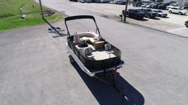 Slide: The Image of 2018 Lexington 5 Series pontoon boat on trailer, parking lot view. - 19