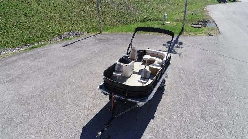 Slide: The Image of 2018 Lexington 5 Series pontoon boat on trailer, parking lot view. - 20