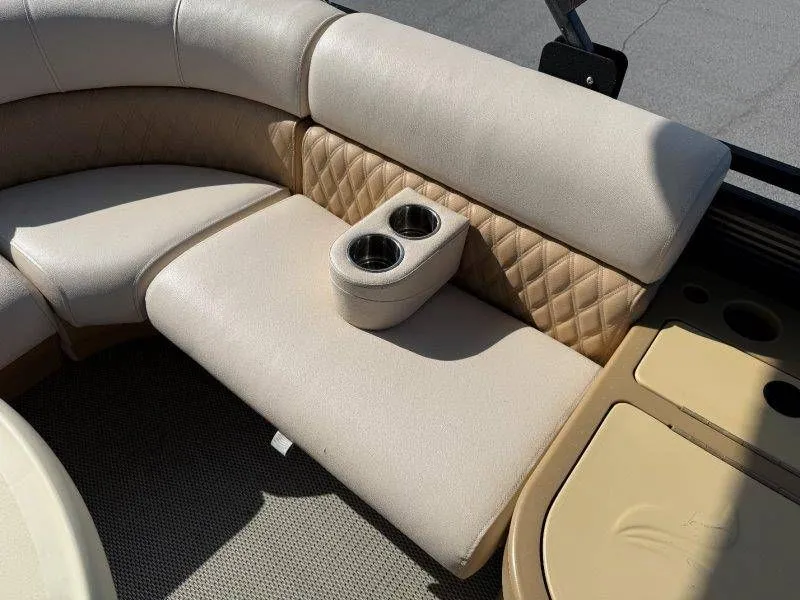 Slide: The Image of Interior of a 2018 Lexington 5 Series with beige upholstery and cup holders. - 24