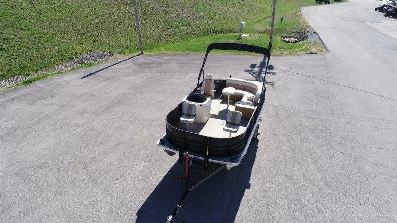 Slide: The Image of Aerial view of a 2018 Lexington 5 Series pontoon boat in a parking lot. - 30