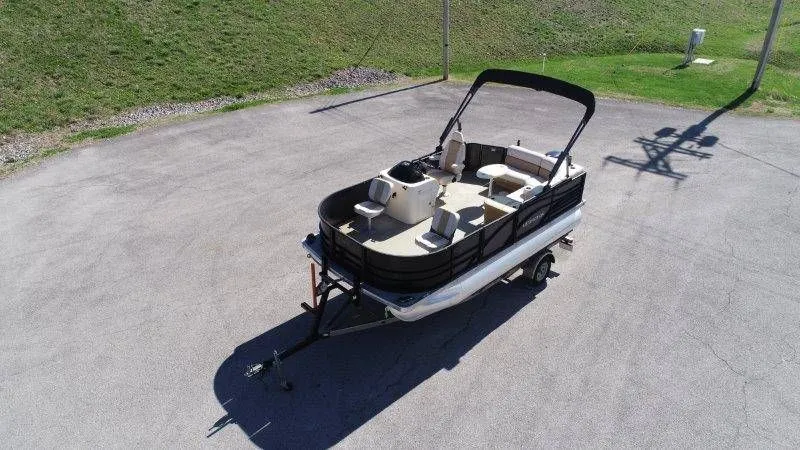 Slide: The Image of 2018 Lexington 5 Series pontoon boat on trailer outdoors. - 7