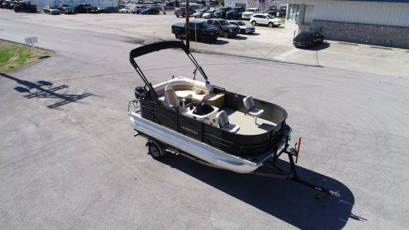 Slide: The Image of 2018 Lexington 5 Series pontoon boat on trailer, parking lot view. - 9