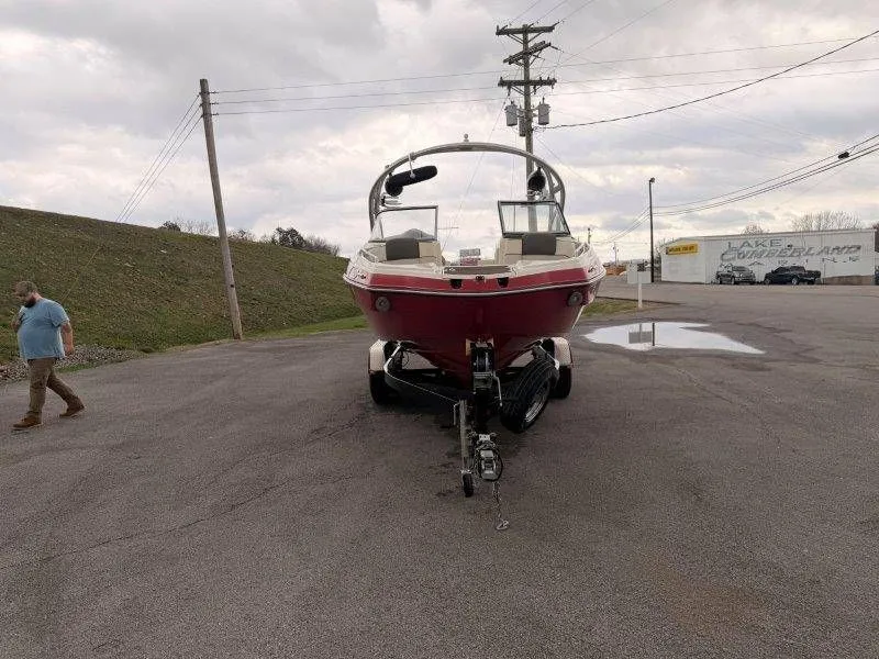 Slide: The Image of 2014 Yamaha Boats 242 Limited S on trailer, parking lot view. - 11