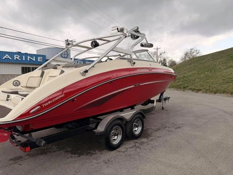 Slide: The Image of 2014 Yamaha Boats 242 Limited S on trailer, red color. - 9