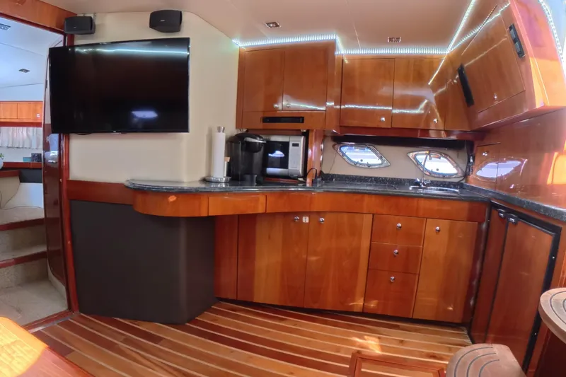 Slide: The Image of Luxurious 2012 Regal 46 Sport Coupe yacht interior with modern kitchen and entertainment area. - 11