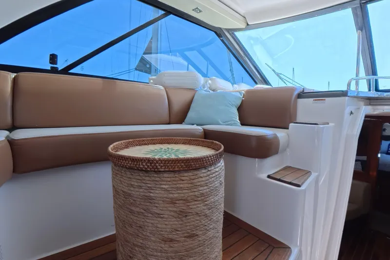 Slide: The Image of Luxurious interior of 2012 Regal 46 Sport Coupe with leather seating and wicker table. - 12