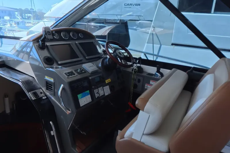 Slide: The Image of Cockpit of 2012 Regal 46 Sport Coupe with modern controls and leather seating. - 5