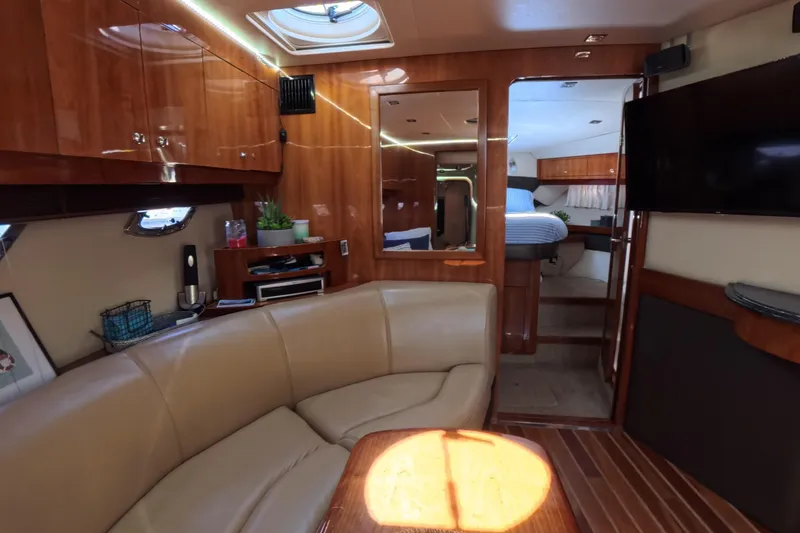 Slide: The Image of Luxurious interior of a 2012 Regal 46 Sport Coupe yacht with leather seating and wood finishes. - 6