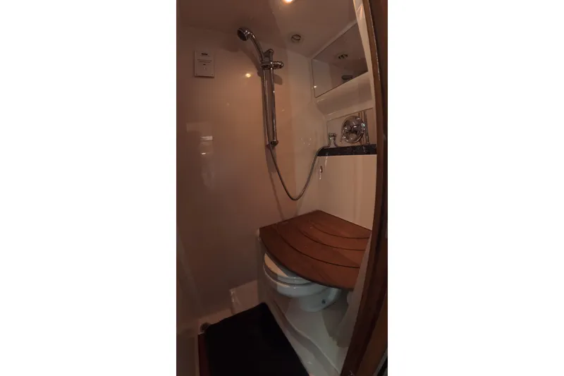 Slide: The Image of 2012 Regal 46 Sport Coupe bathroom with shower and wooden seat. - 8