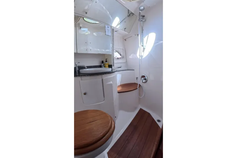 Slide: The Image of Luxurious bathroom in 2012 Regal 46 Sport Coupe yacht with wooden accents and modern fixtures. - 9