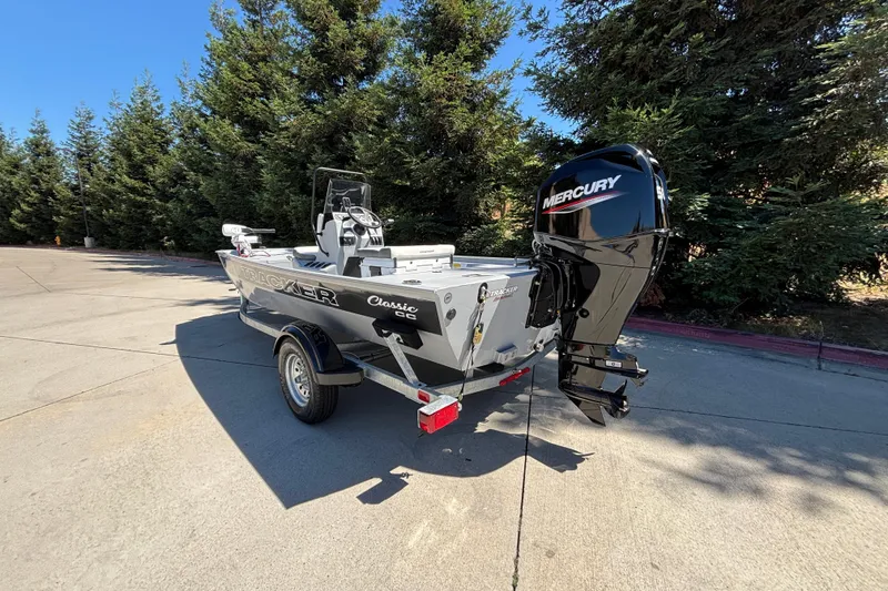Slide: The Image of 2026 Tracker Bass Tracker Classic CC boat with Mercury engine in outdoor setting. - 5