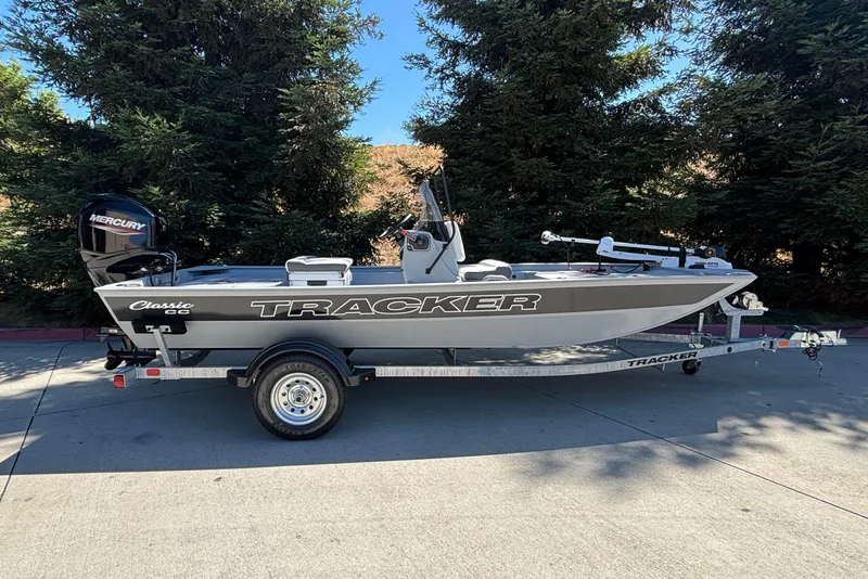 Slide: The Image of 2026 Tracker Bass Tracker Classic CC boat on trailer, parked outdoors. - 2