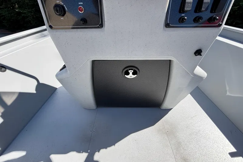 Slide: The Image of 2026 Tracker Bass Tracker Classic CC boat console with control panel and storage compartment. - 16