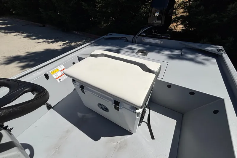 Slide: The Image of 2026 Tracker Bass Tracker Classic CC boat interior with steering wheel and cushioned seat. - 23