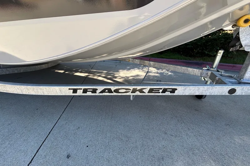 Slide: The Image of 2026 Tracker Bass Tracker Classic CC boat trailer on concrete pavement. - 12