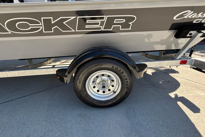 Slide: The Image of 2026 Tracker Bass Tracker Classic CC trailer wheel and side view. - 9