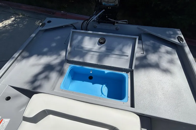 Slide: The Image of 2026 Tracker Bass Tracker Classic CC boat with open storage compartment and blue interior. - 28