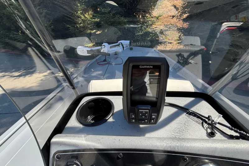 Slide: The Image of 2026 Tracker Bass Tracker Classic CC dashboard with Garmin device and cup holder. - 15