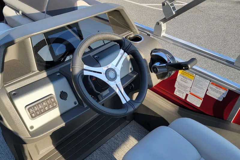 Slide: The Image of 2026 Sun Tracker Party Barge 22 XP3 steering console with modern controls and dashboard. - 88