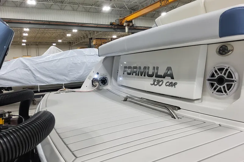 Slide: The Image of 2026 Formula 330 Crossover Bowrider OB in a showroom, showcasing sleek design and branding. - 10