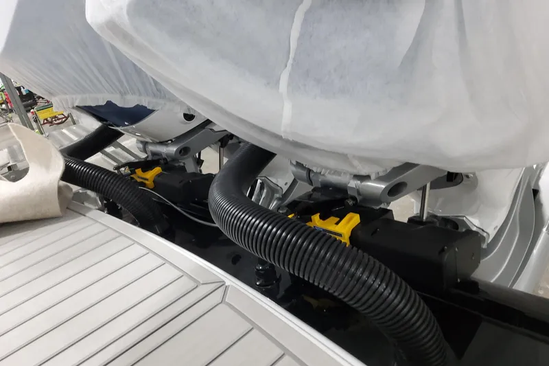 Slide: The Image of 2026 Formula 330 Crossover Bowrider OB engine compartment with protective covers and hoses. - 100