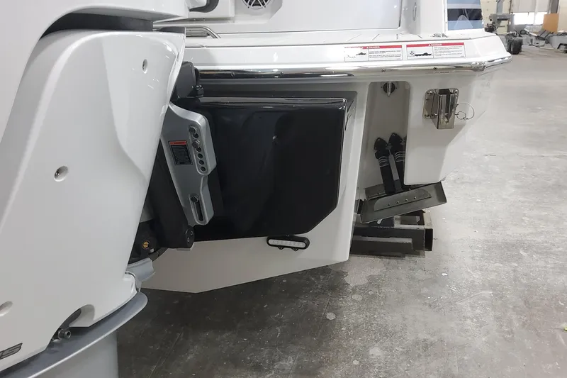 Slide: The Image of 2026 Formula 330 Crossover Bowrider OB boat stern view in a workshop setting. - 14