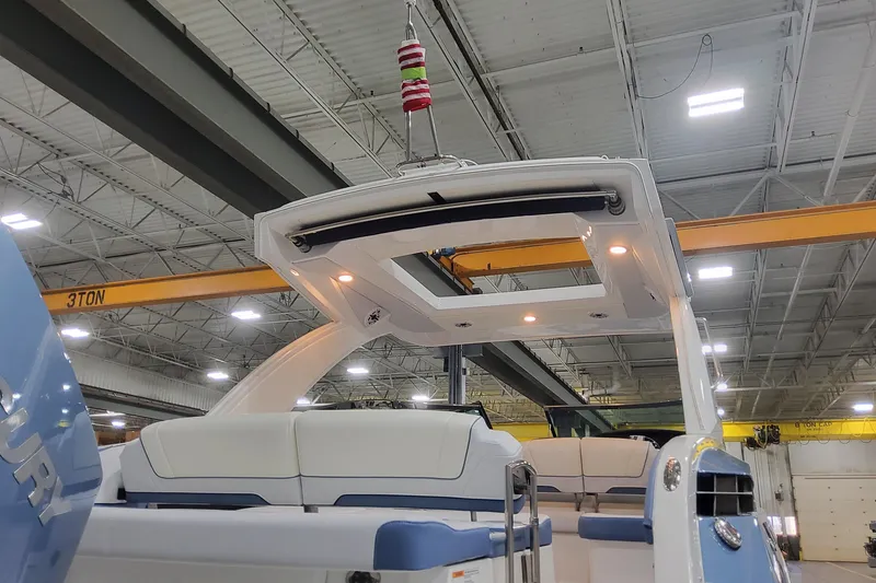 Slide: The Image of 2026 Formula 330 Crossover Bowrider OB in a warehouse, showcasing seating and canopy. - 15