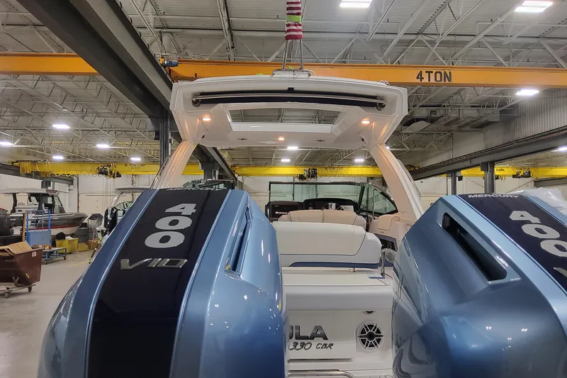 Slide: The Image of 2026 Formula 330 Crossover Bowrider OB with dual Mercury 400 V10 engines in a warehouse. - 18