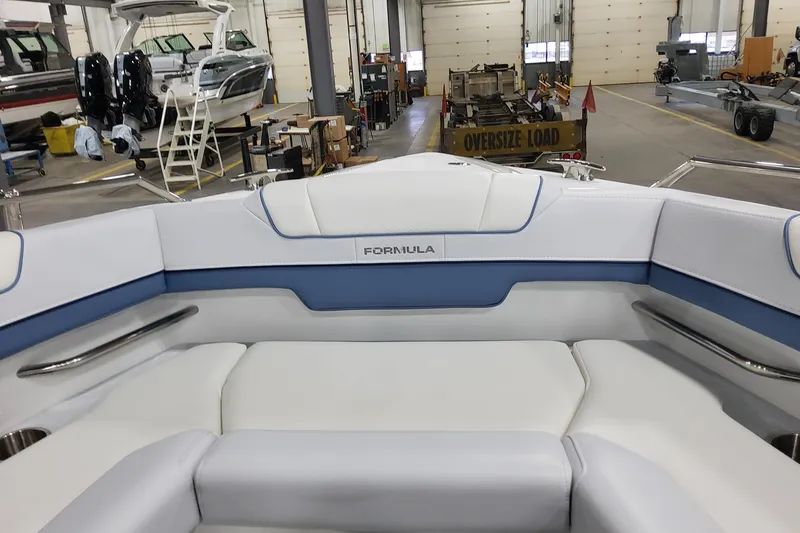 Slide: The Image of 2026 Formula 330 Crossover Bowrider OB interior in a boat showroom. - 31