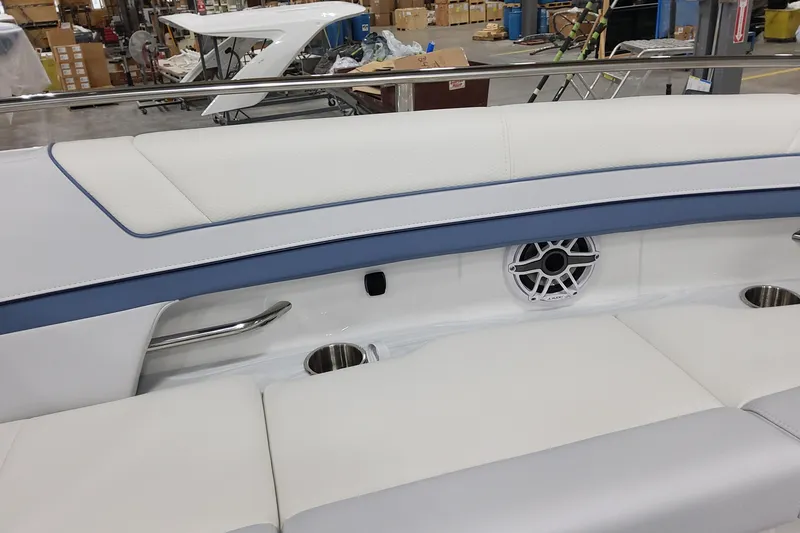 Slide: The Image of Interior of 2026 Formula 330 Crossover Bowrider OB with cushioned seating and speaker. - 33