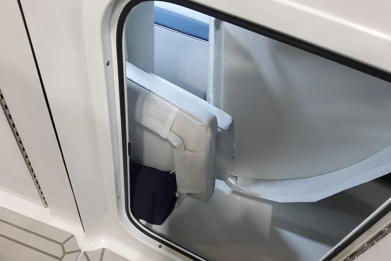 Slide: The Image of 2026 Formula 330 Crossover Bowrider OB interior storage compartment with white cushioned seating. - 38