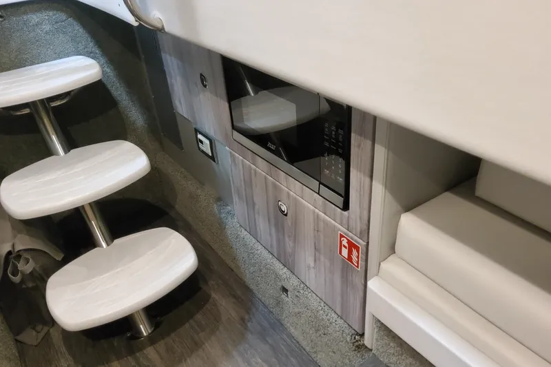 Slide: The Image of Interior of 2026 Formula 330 Crossover Bowrider OB with microwave and modern seating. - 49