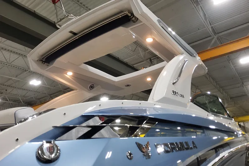 Slide: The Image of 2026 Formula 330 Crossover Bowrider OB in a showroom, showcasing sleek design and modern features. - 5