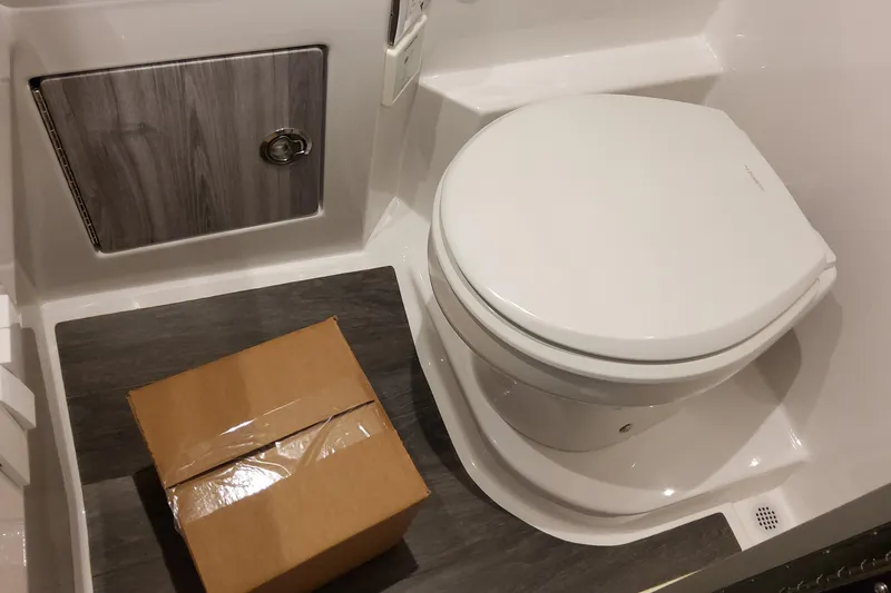 Slide: The Image of Interior of 2026 Formula 330 Crossover Bowrider OB with toilet and storage compartment. - 53