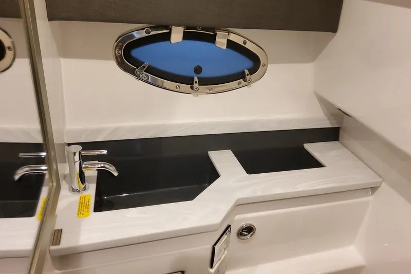 Slide: The Image of Interior of 2026 Formula 330 Crossover Bowrider OB, featuring sleek sink and porthole window. - 54