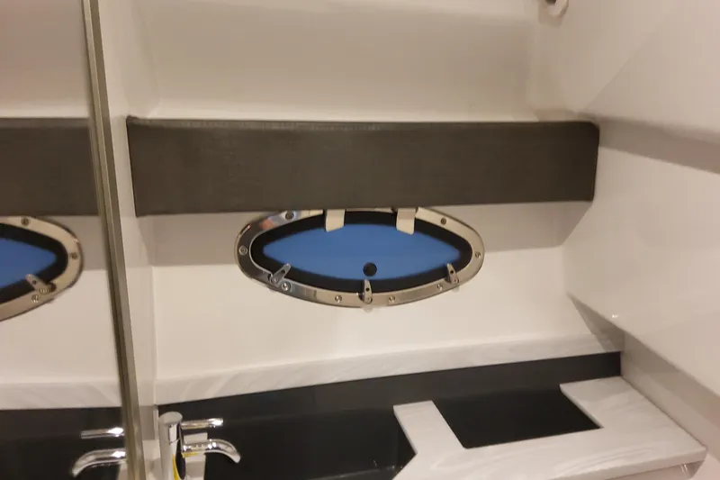 Slide: The Image of Interior of 2026 Formula 330 Crossover Bowrider OB, featuring sleek sink and oval window. - 55