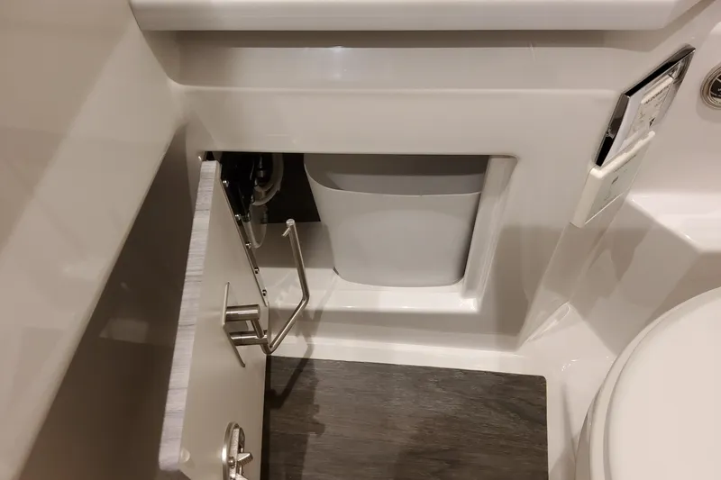 Slide: The Image of Interior of 2026 Formula 330 Crossover Bowrider OB, featuring a compact storage compartment. - 56